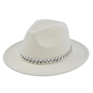 Detail of cream wool fedora hat featuring a chunky silver metal chain on the brim