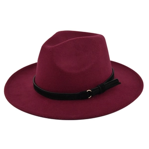 Detail view of burgundy wide brim wool fedora hat with black leather belt and gold hardware
