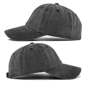 Detail of reinforced stitching on brim and washed cotton texture of charcoal baseball cap