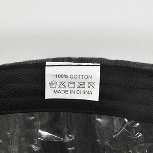 Detail view of the 100% cotton wash label inside a vintage washed grey baseball cap