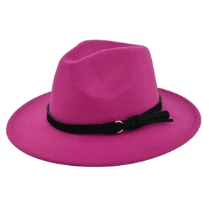 Detail of rose red wide brim fedora with black suede band and golden metal ring