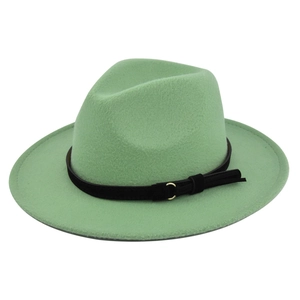 Detail of light green fedora hat with a black leather band and gold metal buckle