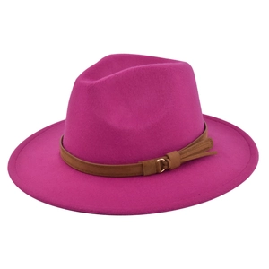 Detail of dark pink wide brim fedora hat featuring brown belt with gold buckle and tassel
