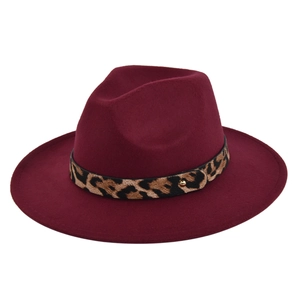Detailed view of burgundy wool fedora featuring a leopard print band and golden rivet