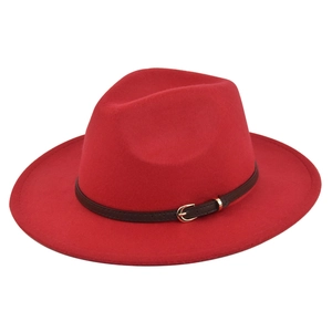 Detail of red fedora wool hat featuring a brown leather belt and gold buckle