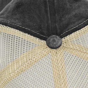 Detailed macro view of gray washed cotton fabric and breathable beige mesh on baseball cap