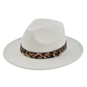 Detail of cream fedora hat featuring a leopard print band and gold stud accent