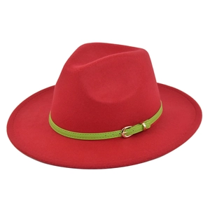 Detail of red wool fedora with vibrant green leather band and gold metal buckle