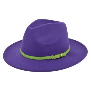 Detail of purple wool fedora hat with vibrant green leather band and gold buckle finish