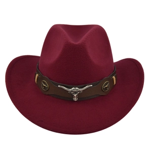 Detailed close-up of wine red cowboy hat featuring leather band and silver bull head emblem