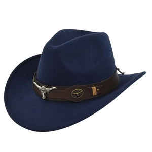 Macro shot of silver bull head metal ornament on dark blue felt cowboy hat leather band