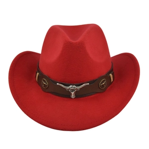 Detail of red cowboy hat featuring leather band and silver longhorn bull head emblem