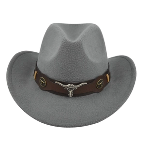 Detail of grey felt cowboy hat featuring silver bull head metal emblem and brown strap