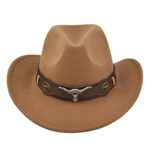 Detail of western cowboy hat featuring silver bull head emblem and leather decorative band