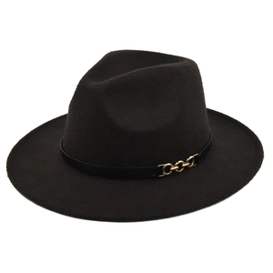 Detail of dark felt fedora hat featuring a black leather band and gold chain buckle