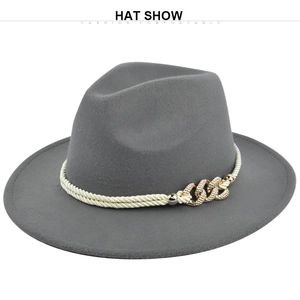 Detail of grey wool fedora hat featuring off-white braided rope and gold metal chain buckle