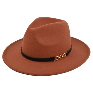 Detail of rust red felt fedora hat featuring black leather band and gold chain accent