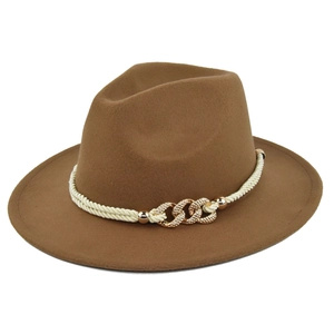 Close-up of caramel wool fedora hat with cream braided cord and gold chain accents