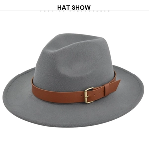 Detail of grey wool fedora hat featuring a brown leather band and gold buckle accent