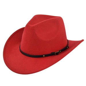 Detailed macro view of vibrant red felt cowboy hat with black leather belt and gold studs