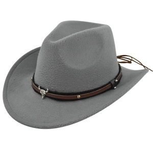 Detail of grey felt cowboy hat featuring silver bull skull and leather band decoration
