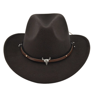 Detail of western cowboy hat featuring silver bull head skull and leather braided band