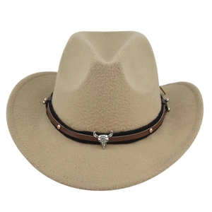 Detail of western cowboy hat with silver bull head skull buckle and braided rivet band