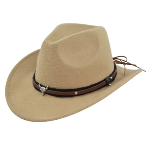 Detail of western cowboy hat featuring a leather band with metal rivets and bull skull