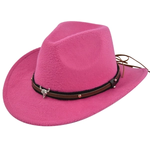 Detail of rose pink felt cowboy hat featuring silver bull skull and leather band