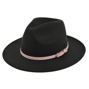 Detail of a black felt fedora hat featuring a pink leather band and a gold buckle accent