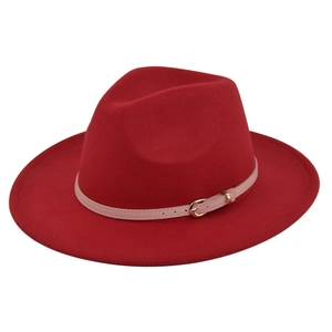 Detail of red wool fedora hat with pink leather strap and gold metal buckle