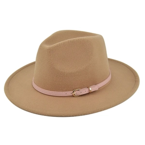 Detail of camel wool fedora hat featuring a pink leather band and gold buckle
