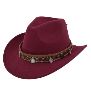 Close-up of wine red wool cowboy hat with ethnic braided band and silver metal coins