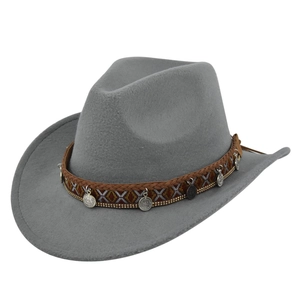 Detail of gray felt cowboy hat featuring ethnic geometric band and silver metal charms