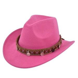 Close-up of pink felt cowboy hat featuring ethnic woven band and vintage metal coin charms