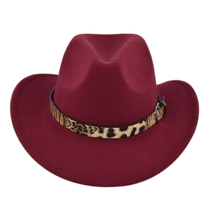 Close-up of burgundy felt cowboy hat featuring leopard print band and metal buckle detail