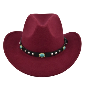 Macro view of burgundy wool fedora with studded black leather band and turquoise stones