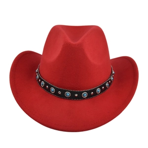 Detail of red cowboy hat with black decorative band, silver studs and turquoise stones