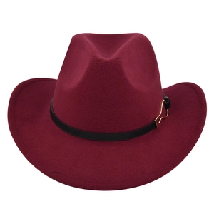 Detail of dark wine red felt fedora with black leather band and golden metal buckle