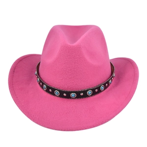 Close-up of hot pink felt cowboy hat with bohemian turquoise and silver studded hatband