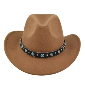 Detailed view of brown felt cowboy hat with black leather band and turquoise bead studs