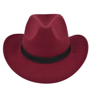 Detail of burgundy felt cowboy hat with wide brim and black leather decorative band