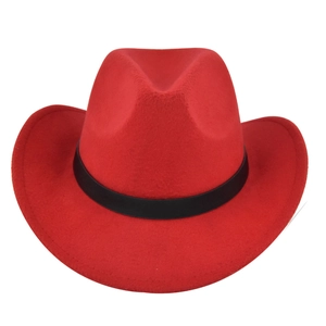 Detail of red cowboy hat featuring a wide brim and contrasting black ribbon band