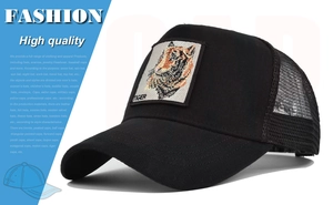 Detail of tiger embroidery patch on black mesh trucker hat with adjustable curved brim