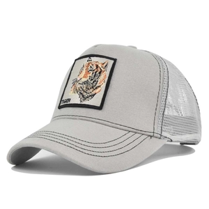 Detailed close-up of tiger embroidery on a light gray mesh trucker baseball cap