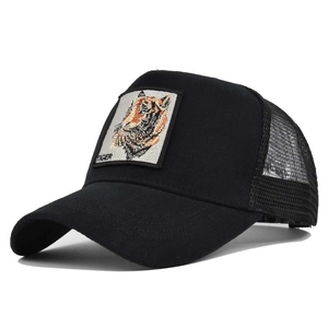 Detailed close-up of tiger embroidery patch on black mesh trucker baseball cap