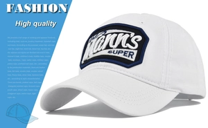 Close-up of white cotton baseball cap featuring detailed 3D embroidered Mann's shield patch