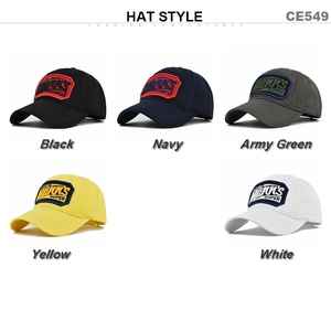Detail view of cotton baseball caps showing embroidered patches in five different colors