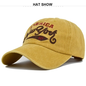 Close-up of vintage yellow washed cotton cap with New York embroidery and fabric texture