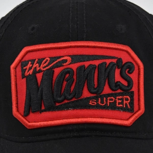 Black cotton baseball cap featuring red 3D Mann's embroidery with a classic shield design